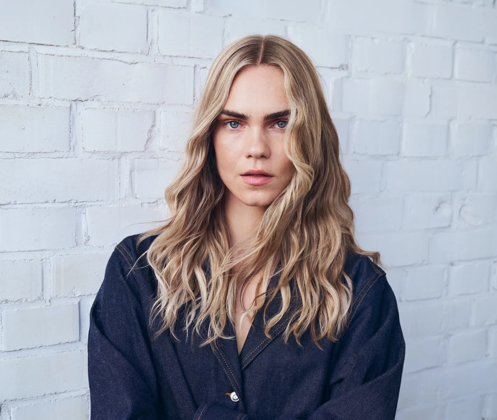 Goldwell blonde colour inspiration with softly waved beige-blonde hair