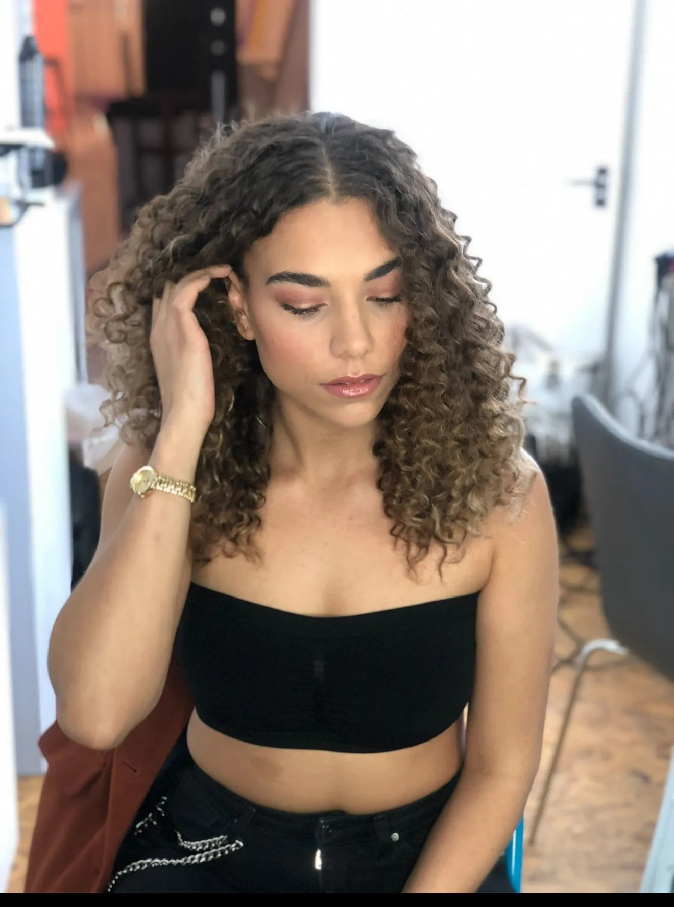 PROJECT AFRO model showing the finished brunette curl shape with a centre parting.