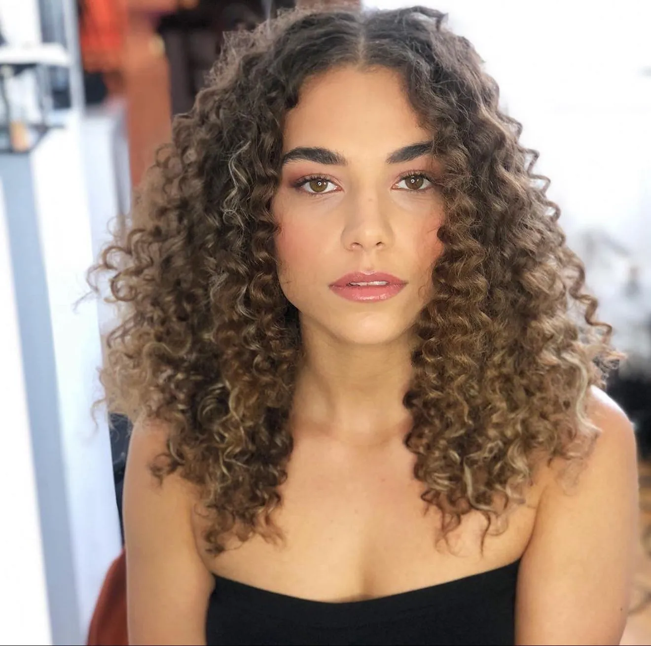 Front view of the PROJECT AFRO model’s defined brunette curls styled by Claire.