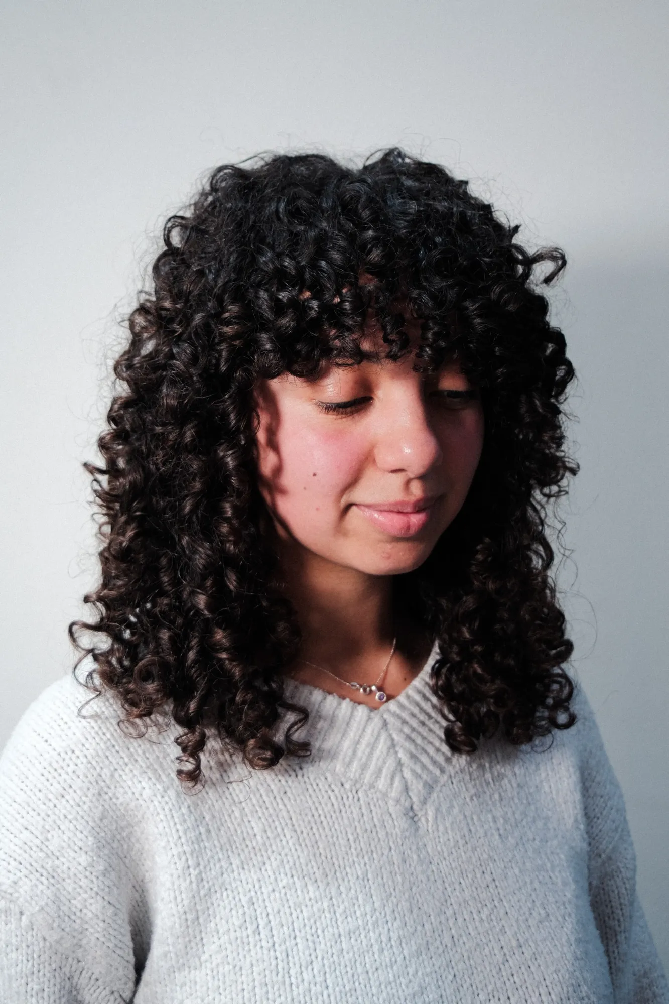 Defined dark curls and a curly fringe styled by Claire at Wigs & Warpaint in Sheffield.