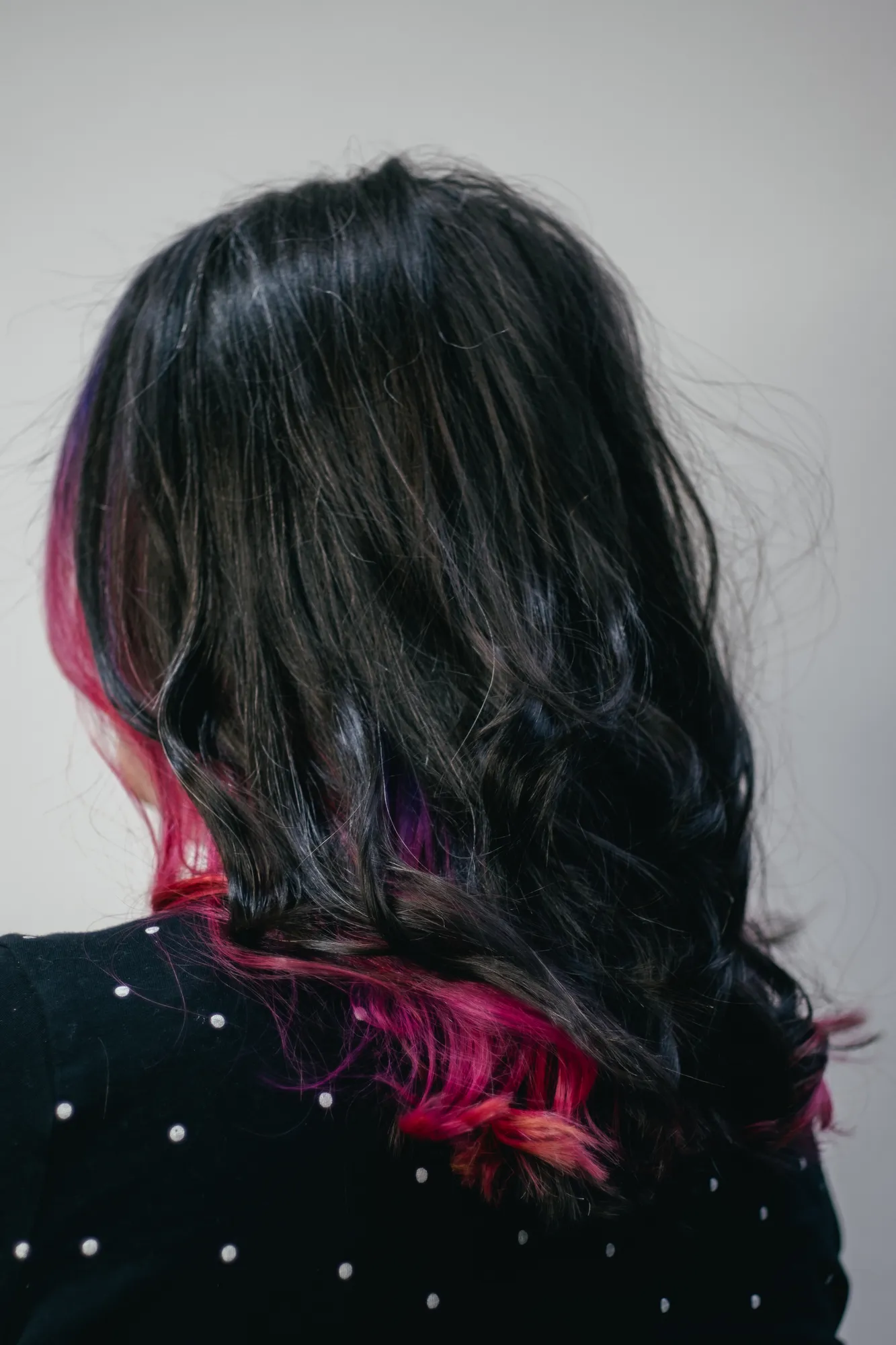 Dark hair with a pink underlayer by Adam at Wigs & Warpaint, Sheffield