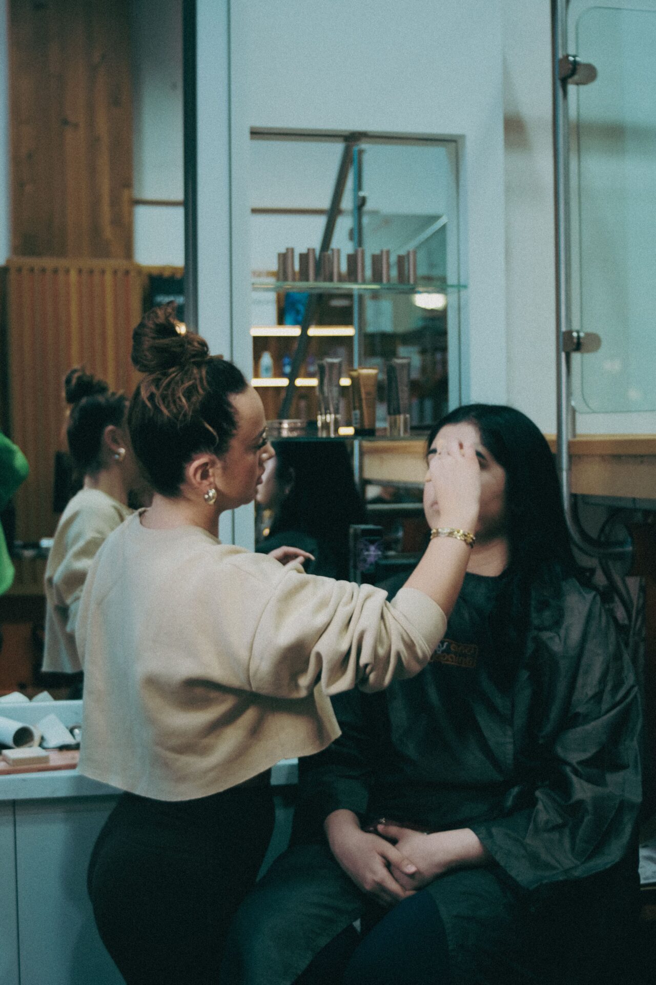 Makeup artist applying makeup to a client at Wigs & Warpaint Sheffield